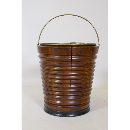 1178 - A fruitwood peat bucket with ebonised base and brass handle and liner, 33cm high