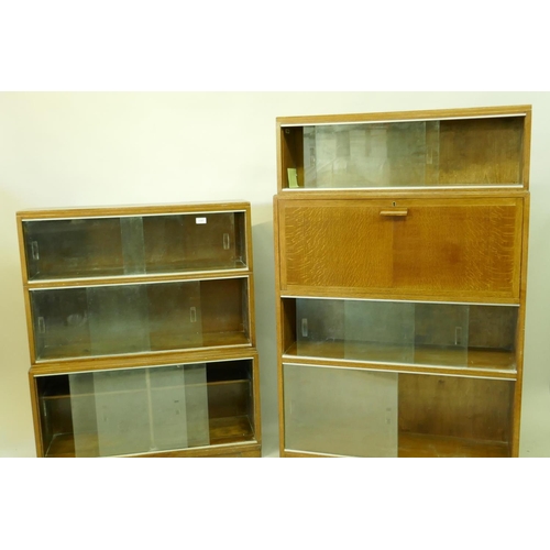 1197 - A 'Minty' mid century oak stepped front bookcase with sliding glass doors, 90 x 29 x 108cms, and ano... 