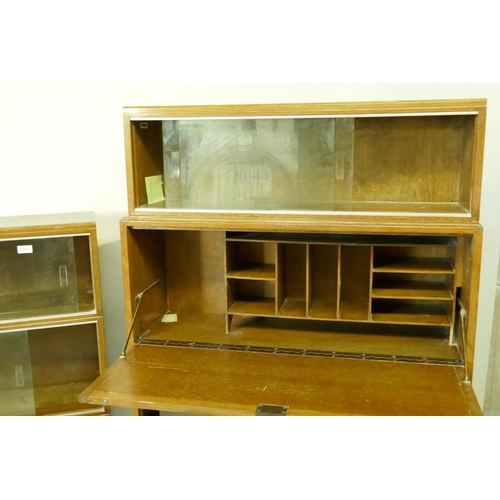 1197 - A 'Minty' mid century oak stepped front bookcase with sliding glass doors, 90 x 29 x 108cms, and ano... 