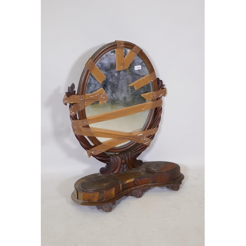 1204 - A C19th mahogany swing toilet mirror, with oval mirror and two wells, AF, 85cm high