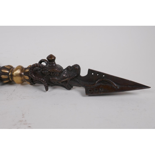 16 - A Tibetan bronzed metal phurba, the handle in the form of Ganesh, 32cm long