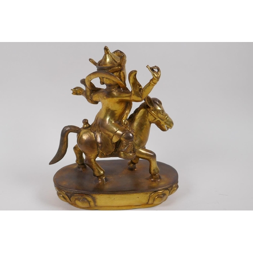 17 - A Chinese gilt bronze figure of a deity on horseback, 23cm high