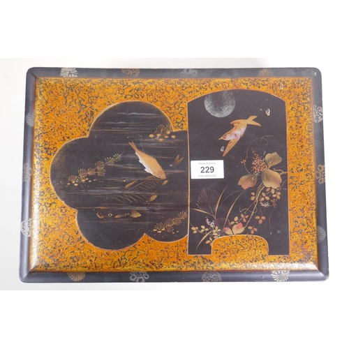 2 - A Meiji lacquer box with gilt decoration of carp and a birds in a moonlit sky, 36 x 26 x 13 cm