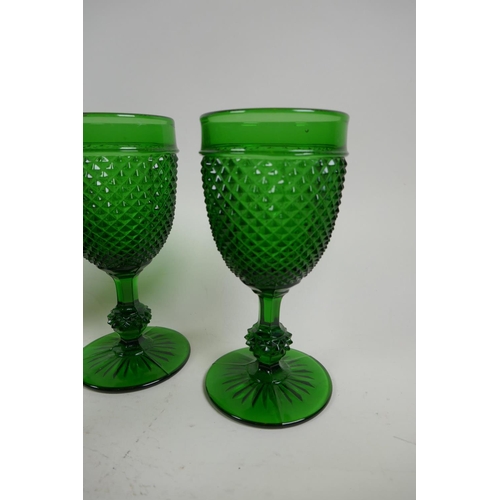 24 - A set of five green pressed glass wine goblets with hobnail design, 16cm, together with two coloured... 