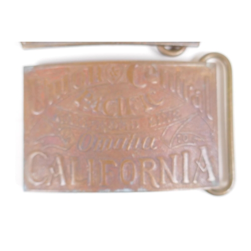 26 - A pair of Tiffany style brass belt buckles advertising 'Wells Cargo' and 'Union Central', 9 x 6cm