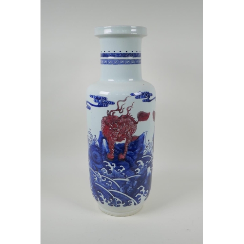 4 - A Chinese blue and white porcelain rouleau vase with red mythical creature decoration, 45cm high