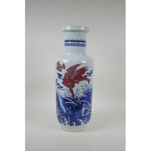 4 - A Chinese blue and white porcelain rouleau vase with red mythical creature decoration, 45cm high