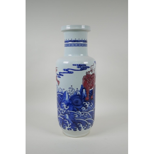 4 - A Chinese blue and white porcelain rouleau vase with red mythical creature decoration, 45cm high