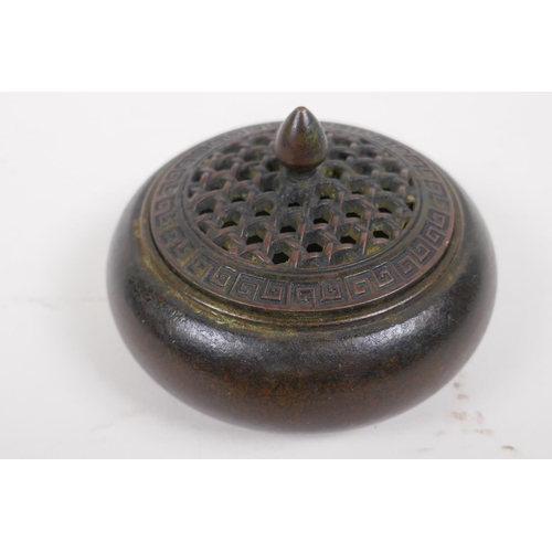 41 - An oriental bronze censer with pierced cover, 10cm diameter