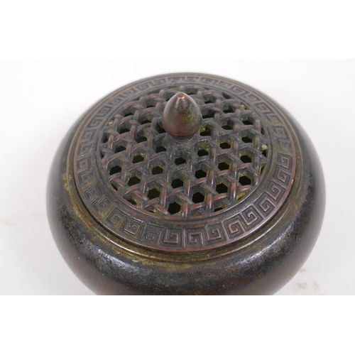 41 - An oriental bronze censer with pierced cover, 10cm diameter