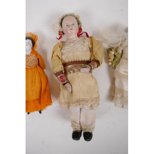 42 - A collection of C19th porcelain and composition dolls in tailored clothing, largest 23cm