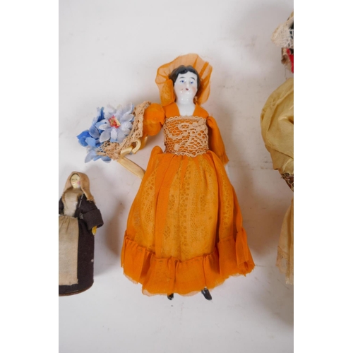 42 - A collection of C19th porcelain and composition dolls in tailored clothing, largest 23cm