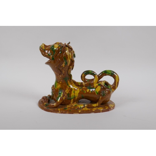 45 - A late C19th/early C20th Turkish canakkale pottery lion, with yellow, green and brown drip glaze, 22... 