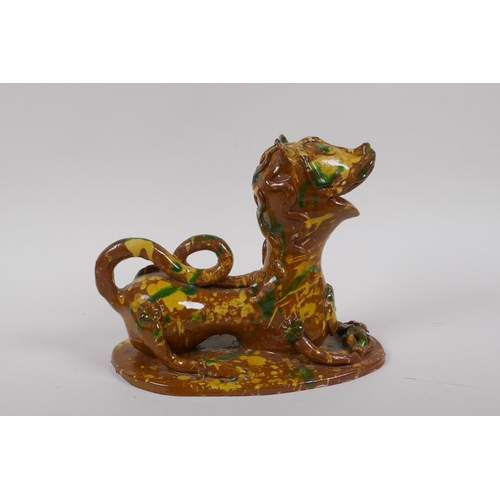 45 - A late C19th/early C20th Turkish canakkale pottery lion, with yellow, green and brown drip glaze, 22... 