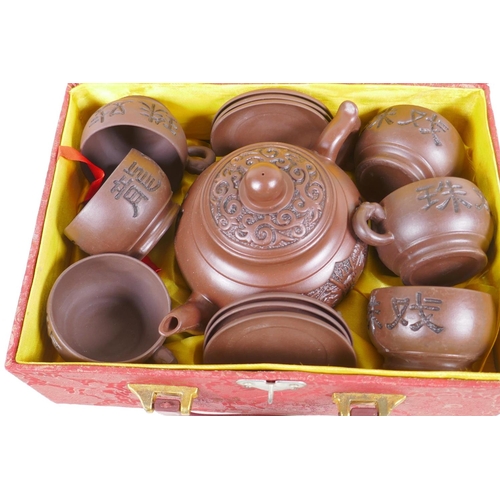 49 - A Chinese Yixing earthenware tea set comprising tea pot, and six cups and saucers