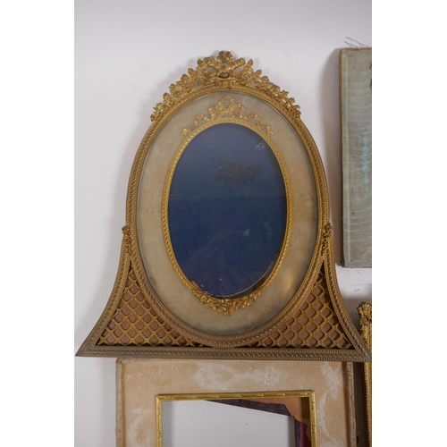 5 - A brass and ormolu photo frame with Empire style decoration and watered silk border, late C19th/earl... 