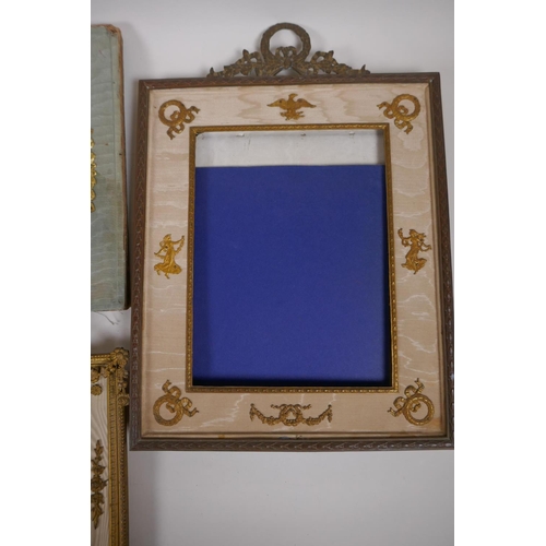 5 - A brass and ormolu photo frame with Empire style decoration and watered silk border, late C19th/earl... 