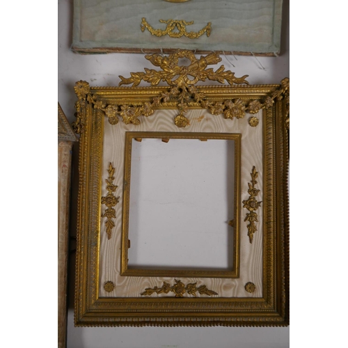 5 - A brass and ormolu photo frame with Empire style decoration and watered silk border, late C19th/earl... 