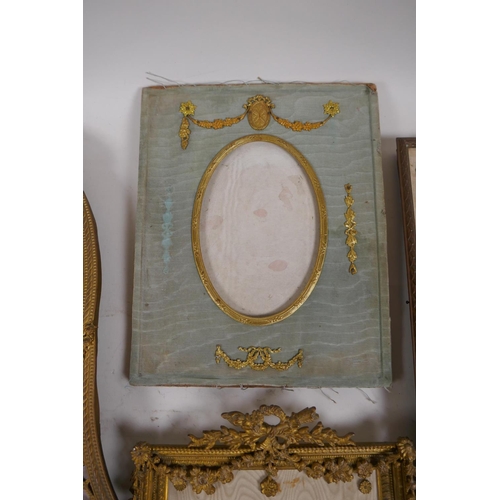 5 - A brass and ormolu photo frame with Empire style decoration and watered silk border, late C19th/earl... 