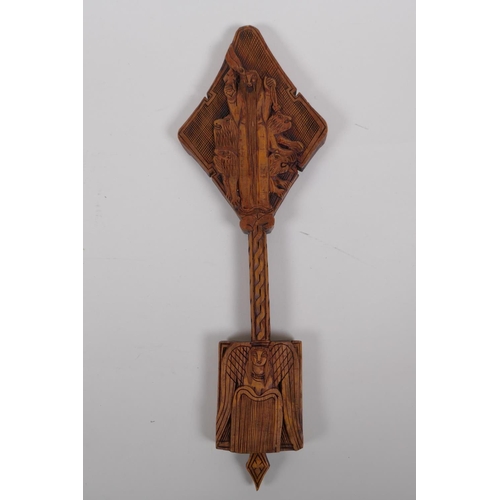 54 - An Ethiopian carved wood coptic cross with figural decoration, 42cm long