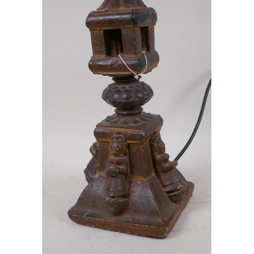 57 - An Indian carved wood table lamp in the form of a temple with applied figural decoration, 44cm high