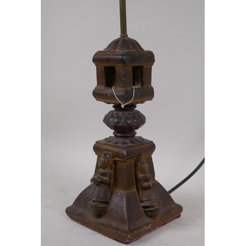 57 - An Indian carved wood table lamp in the form of a temple with applied figural decoration, 44cm high