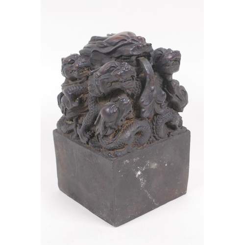 63 - A bronze seal cast with a dragon and young, with Chinese character marks to seal, 8.5cm square, 14cm... 