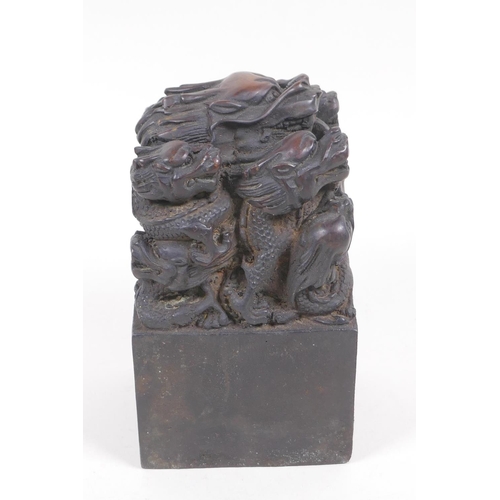 63 - A bronze seal cast with a dragon and young, with Chinese character marks to seal, 8.5cm square, 14cm... 