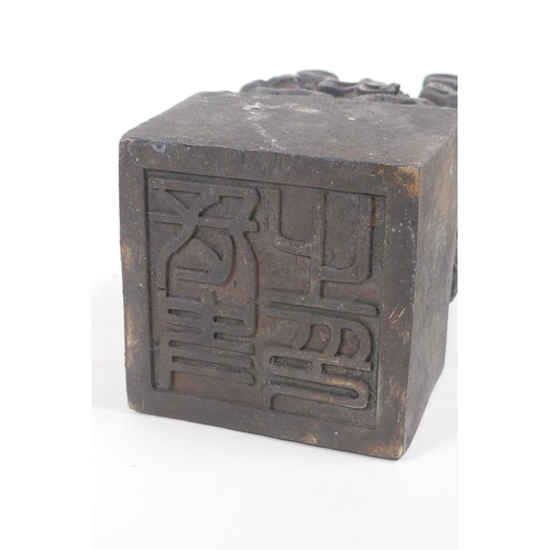 63 - A bronze seal cast with a dragon and young, with Chinese character marks to seal, 8.5cm square, 14cm... 