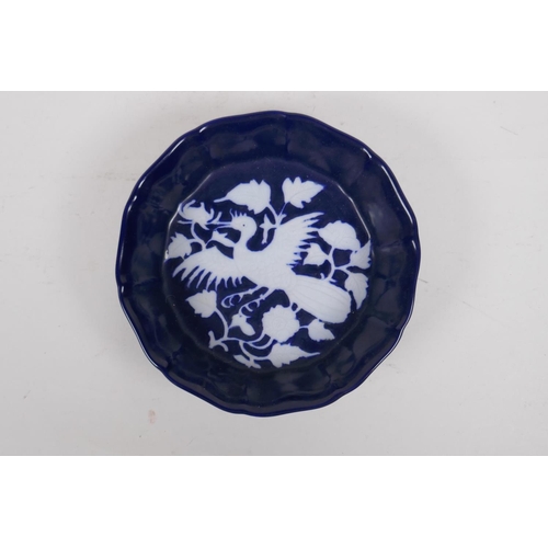 66 - A Chinese powder blue ground dish of lobed form with white phoenix decoration, 18cm diameter