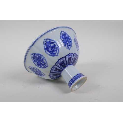 68 - A blue and white porcelain stem bowl of lobed form with ribbed stem and dragon decoration, Chinese X... 