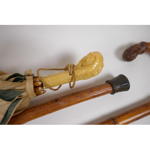 8 - A collection of walking sticks including an ebonised stick with a hallmarked silver cuff, and a horn... 