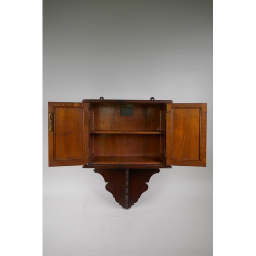 81 - A late C19th oak hanging smoker's cabinet constructed from timbers of H.M.S. Victory, brass plaque t... 