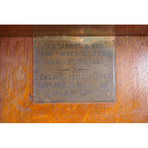 81 - A late C19th oak hanging smoker's cabinet constructed from timbers of H.M.S. Victory, brass plaque t... 