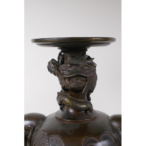 7 - A pair of Meiji bronze stands with elephant mask handles, fo dog and dragon detail and panels depict... 