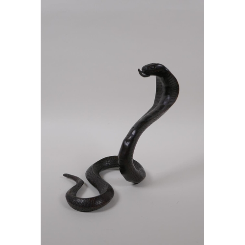 10 - A filled bronze figure of a cobra, 18cm high