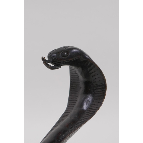 10 - A filled bronze figure of a cobra, 18cm high