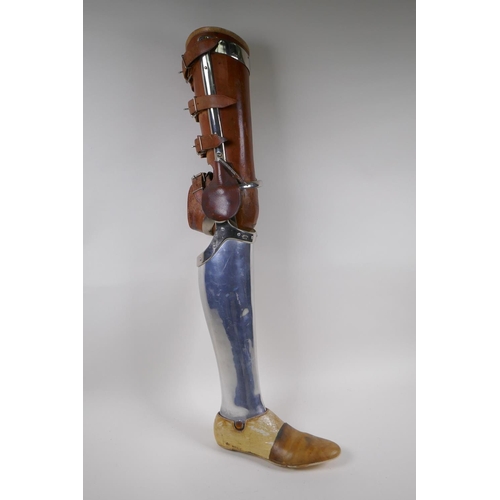 100 - An early C20th French leather and metal prosthetic leg by Leridon of Paris, 76cm 