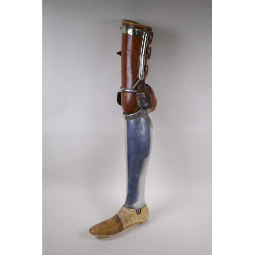 100 - An early C20th French leather and metal prosthetic leg by Leridon of Paris, 76cm 