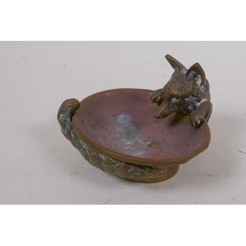 104 - A brass ashtray cast as a fox curled around a water bowl, 10cm wide