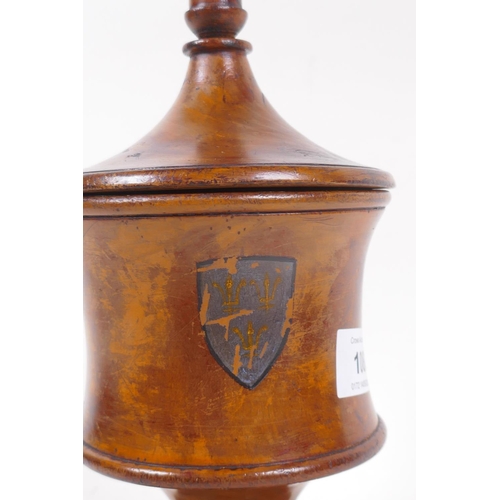 108 - A treen turned fruitwood tobacco jar/tea caddy with cover and painted heraldic shield, 25cm high