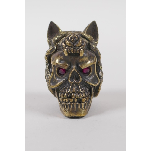 11 - A brass vesta case in the form of a skull wearing a wolf's head hat, 5cm