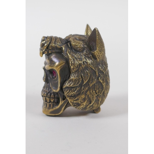 11 - A brass vesta case in the form of a skull wearing a wolf's head hat, 5cm