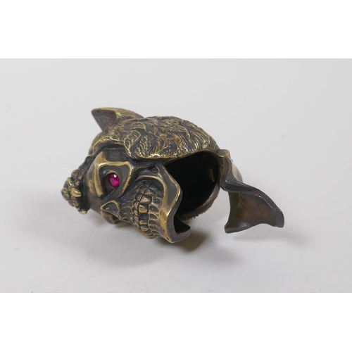 11 - A brass vesta case in the form of a skull wearing a wolf's head hat, 5cm