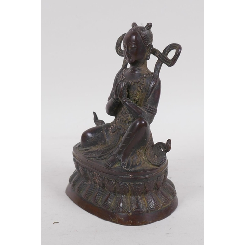 119 - A bronze Buddha seated upon a stylised lotus throne, 16cm high