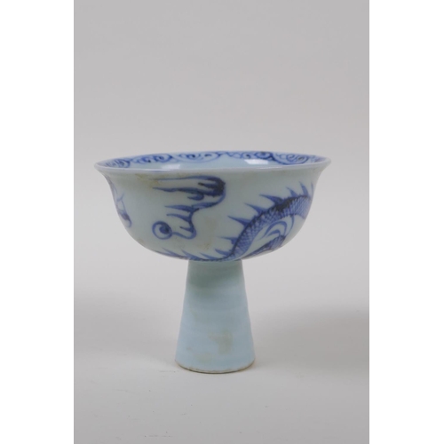 130 - A Chinese blue and white porcelain stem cup with dragon decoration and ribbed stem, 9cm high x 10cm ... 