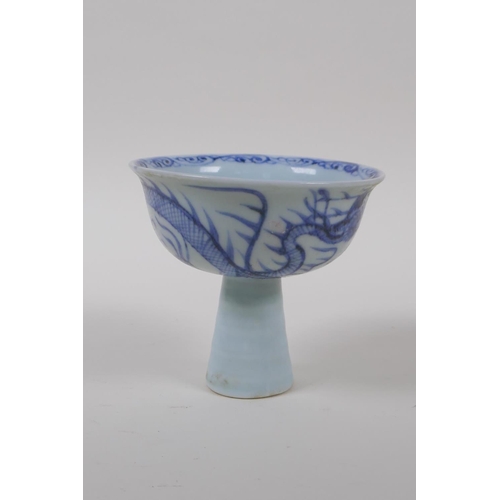 130 - A Chinese blue and white porcelain stem cup with dragon decoration and ribbed stem, 9cm high x 10cm ... 