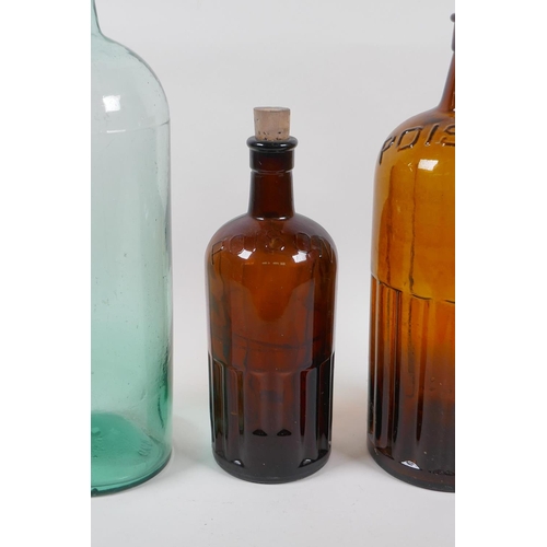 136 - Two vintage brown ribbed glass poison bottles and a similar green glass bottle, largest 39cm high