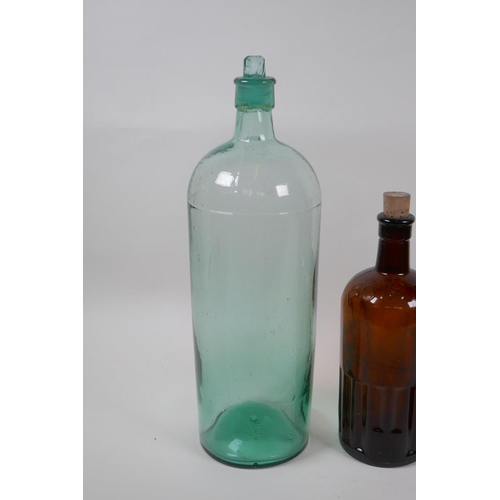 136 - Two vintage brown ribbed glass poison bottles and a similar green glass bottle, largest 39cm high