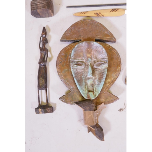 139 - A collection of African and Asian ethnographic items including a Yoruba wall mask, two primitive cop... 